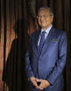 CORRECTS SPELLING OF PRIME MINISTER'S NAME - Malaysia's Prime Minister Mahathir Mohamad poses for a portrait after an interview with The Associated Press in Putrajaya, Malaysia, Monday, Aug. 13, 2018. Mahathir said he will seek to cancel multibillion-dollar Chinese-backed infrastructure projects that were signed by his predecessor as his government works to dig itself out of debt, and he blasted Myanmar’s treatment of its Rohingya minority as "grossly unjust." (AP Photo/Yam G-Jun)