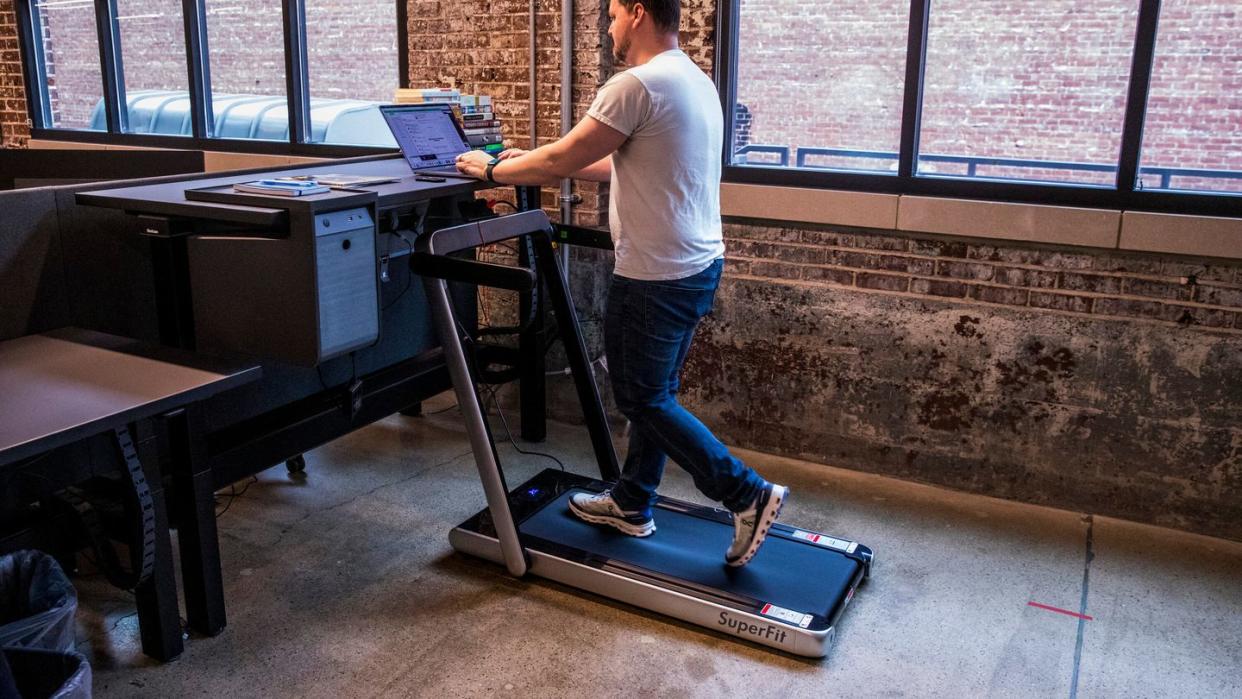 a man using an under desk treadmill