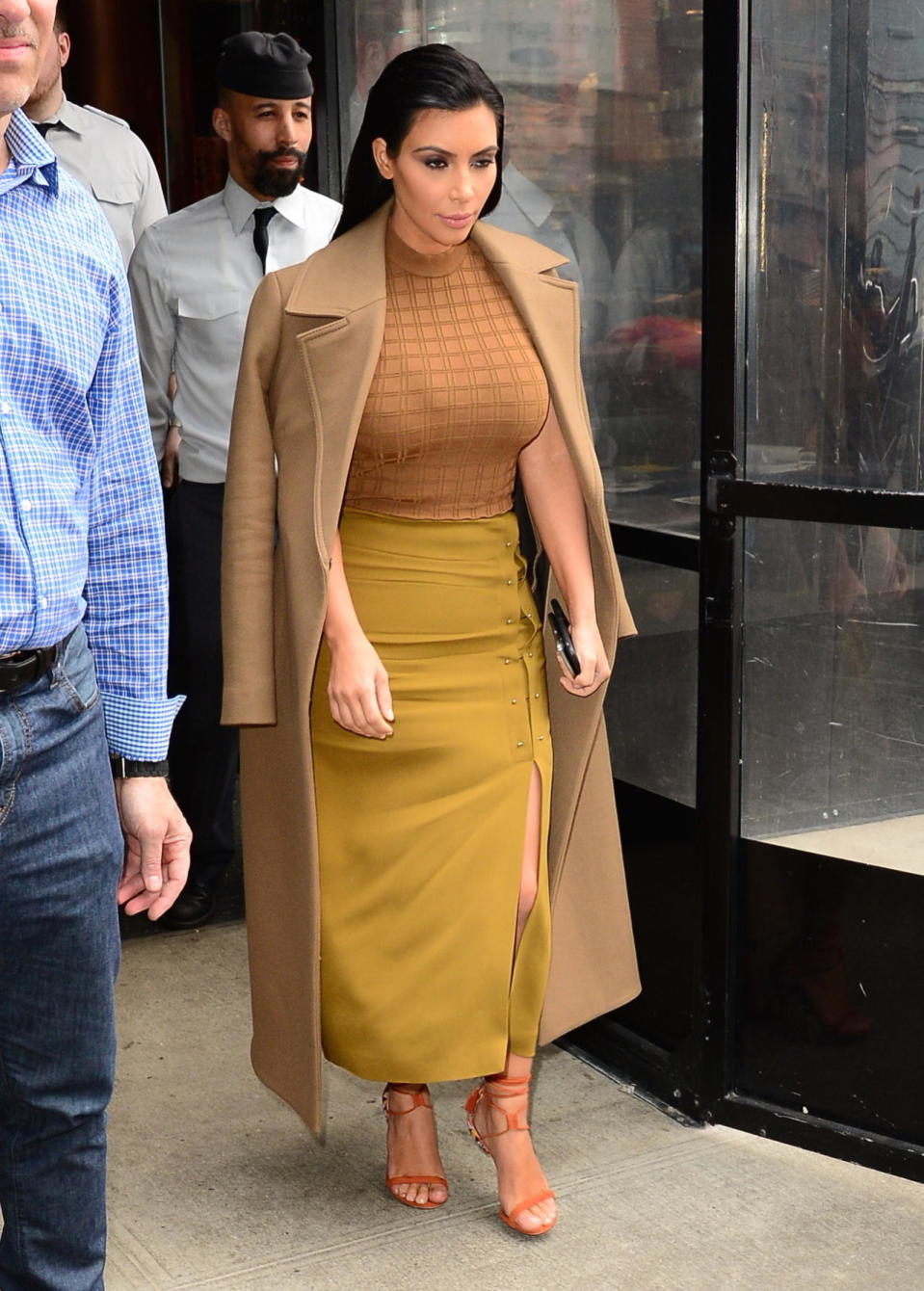 <p>This is how Kim Kardashian does autumn dressing: Adding a seasonally appropriate mustard skirt to her usual palette of nudes. </p>