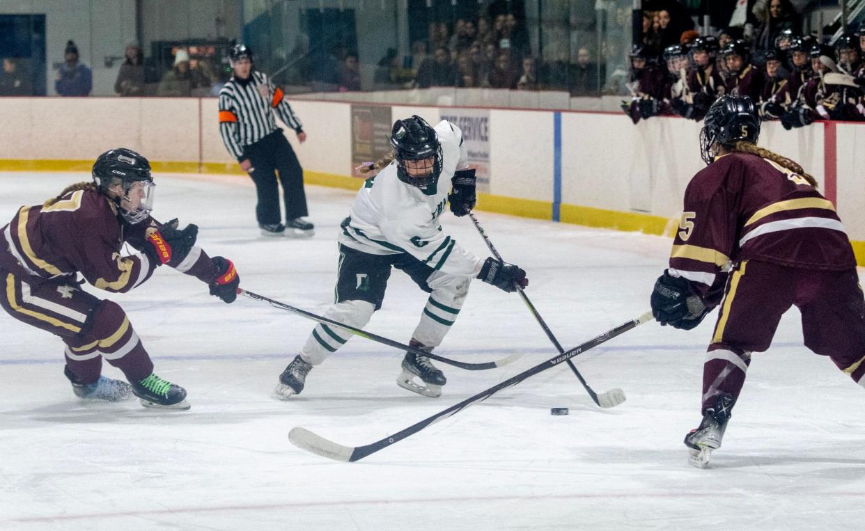 FRAMINGHAM - Algonquin’s Annabelle Biagini and Brenna Joyce defend against Duxbury’s Zoey Madigan in the D2 state girls' hockey semifinal at the Loring Ice Arena Saturday, March 9, 2024.