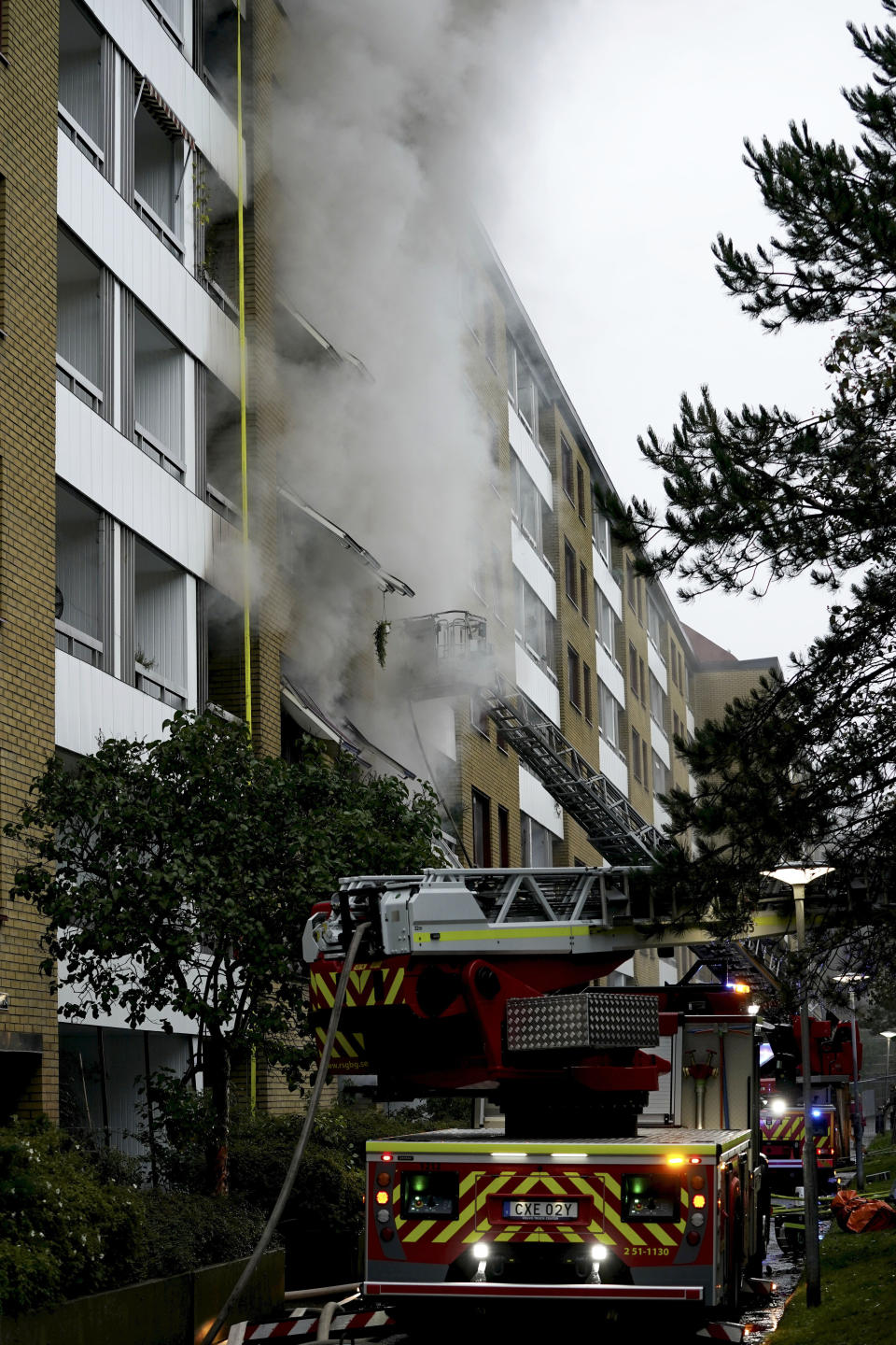 Emergency services attend the scene of an apartment building after an explosion in Annedal, central Gothenburg, Sweden, Tuesday Sept. 28, 2021. The explosion took place in the early hours of the morning, and rescue services are still working to extinguish fires that spread to several apartments. (Bjorn Larsson Rosvall/TT via AP)