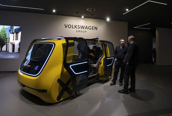 Attendees look at a Volkswagen AG (VW) Sedric concept electric autonomous robo-taxi ahead of the 88th Geneva International Motor Show in Geneva, Switzerland, on March 5, 2018. The show opens to the public on March 8. Photographer: Chris Ratcliffe/Bloomberg