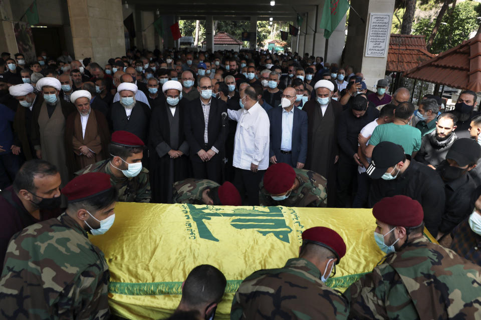 Hezbollah fighters carry the coffin of Ali Atwa, a senior Hezbollah operative, during his funeral procession in the southern Beirut suburb of Dahiyeh, Lebanon, Saturday, Oct. 9, 2021. Atwa was placed on the FBI's most wanted list in 2001, with two other alleged participants in the 1985 hijacking of TWA Flight 847, one of the worst hijackings in aviation history and that lasted for 16 days. (AP Photo/Bilal Hussein)