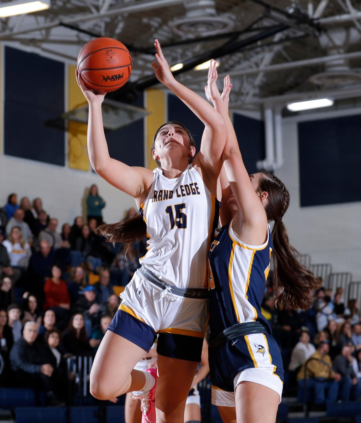 Grand Ledge's Alayna Armstrong, left, shoots against Haslett's Durrgen McIntosh, Tuesday, Dec. 5, 2023, in Grand Ledge.