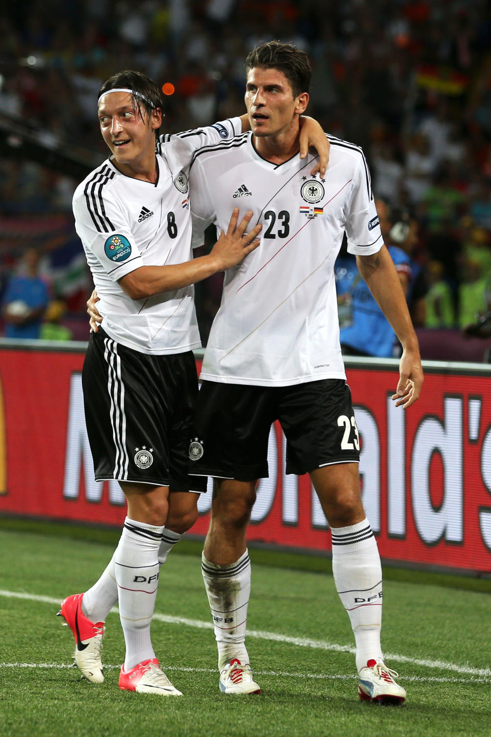 KHARKOV, UKRAINE - JUNE 13: Mario Gomez of Germany celebrates scoring their second goal with Mesut Ozil of Germany during the UEFA EURO 2012 group B match between Netherlands and Germany at Metalist Stadium on June 13, 2012 in Kharkov, Ukraine. (Photo by Ian Walton/Getty Images)