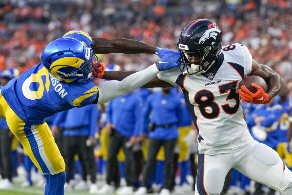 Denver Broncos wide receiver Marvin Mims Jr. is tackled by Los Angeles Rams cornerback Tre Tomlinson during the first half of an NFL football game Saturday, Aug. 26, 2023, in Denver. (AP Photo/David Zalubowski)