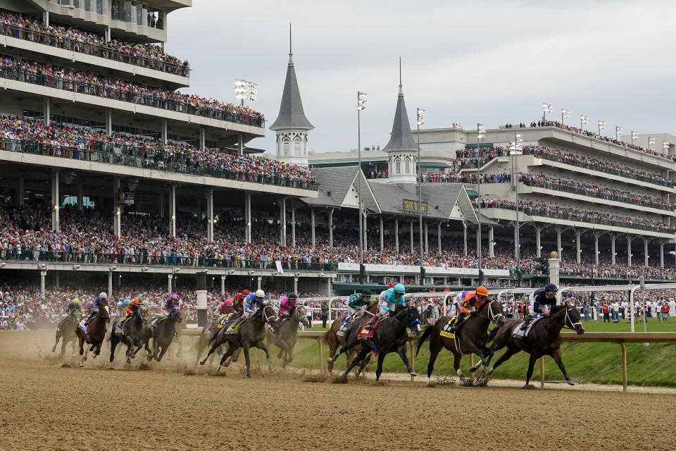 Horses come through the first turn during the 149th running of the Kentucky Derby horse race at Churchill Downs Saturday, May 6, 2023, in Louisville, Ky. (AP Photo/Julio Cortez)