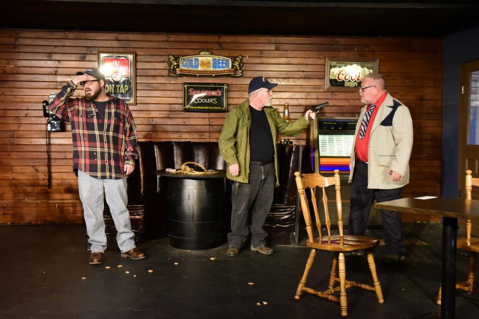 Aaron McNulty panics as a regular, played by Carl Hunnell, points his gun at a visitor, played by Karl Schuster, before the world is scheduled to end during the play "Early One Evening at the Rainbow Bar and Grill."