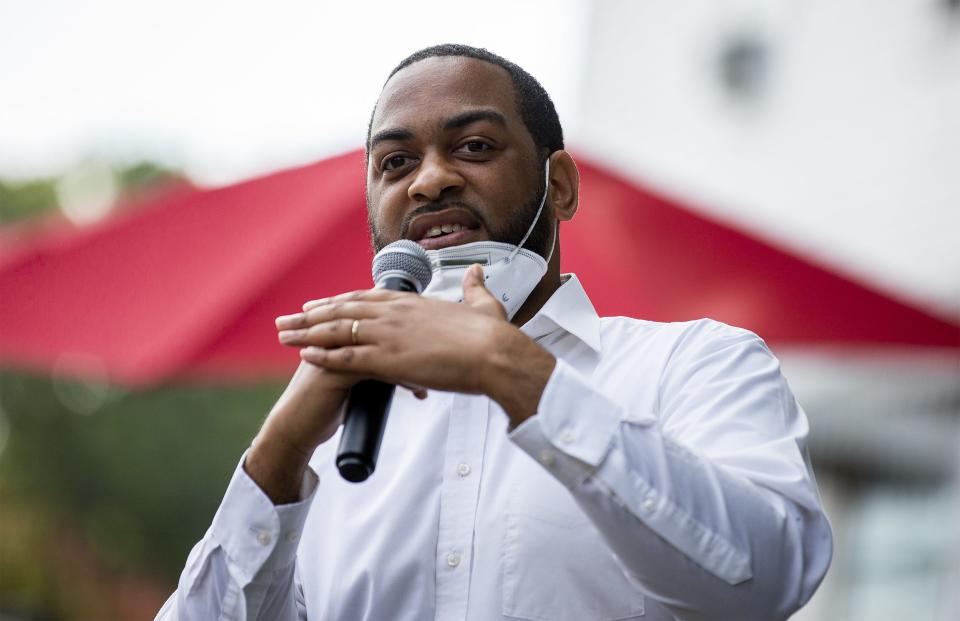 State Rep. Charles Booker gestures while speaking to an enthusiastic crowd at Highland Coffee Company on Bardstown Road on Wednesday, June 17, 2020.