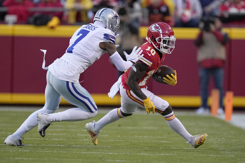 Kansas City Chiefs wide receiver Tyreek Hill (10) runs with the ball as Dallas Cowboys cornerback Trevon Diggs (7) defends during the first half of an NFL football game Sunday, Nov. 21, 2021, in Kansas City, Mo. (AP Photo/Charlie Riedel)