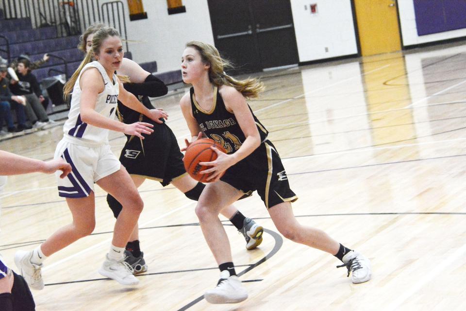 Jillian Fraser (21) of St. Ignace is defended by Madison Thurmes (1) of Pickford during Wednesday's game.