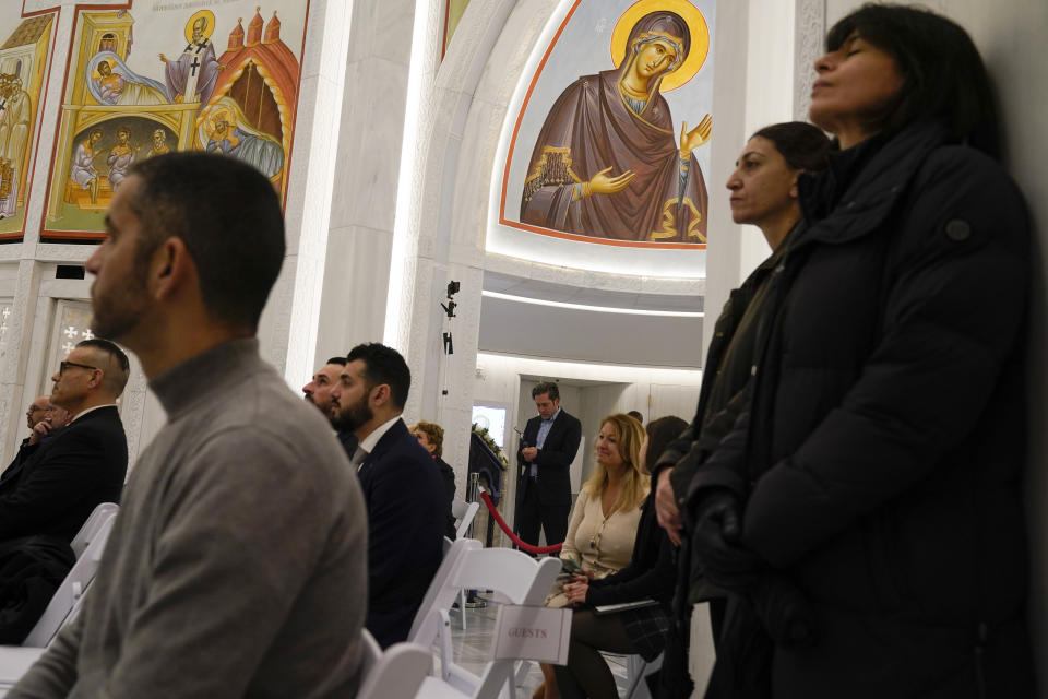 People attend a service at St. Nicholas Greek Orthodox Church in New York, Tuesday, Dec. 6, 2022. After a rebuilding process that lasted more than two decades, the Greek Orthodox church that was destroyed in the Sept. 11 attacks has reopened at the World Trade Center site. The St. Nicholas Greek Orthodox Church and National Shrine, designed by architect Santiago Calatrava, now overlooks the Trade Center memorial pools from an elevated park. (AP Photo/Seth Wenig)