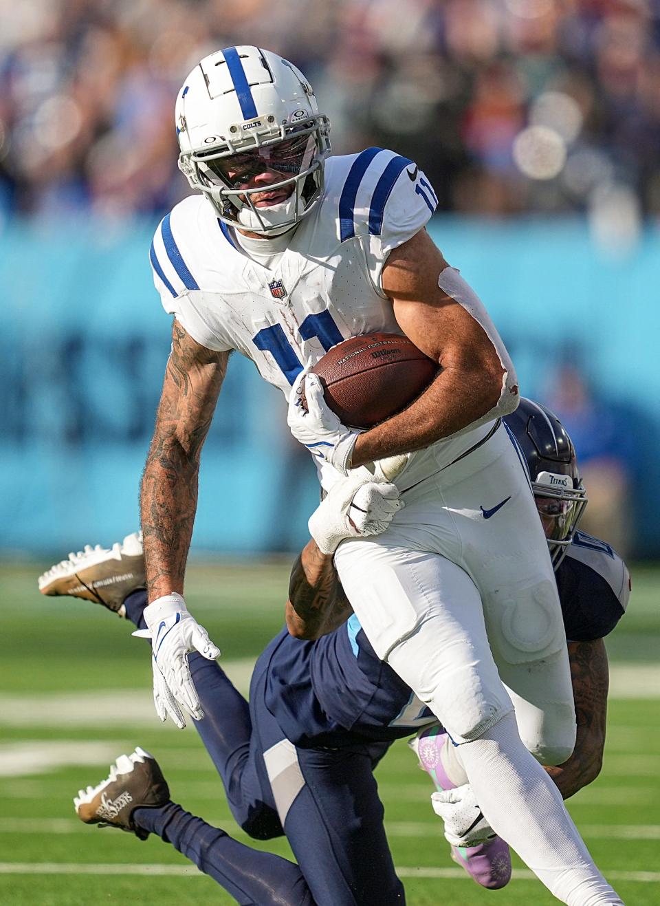 Tennessee Titans cornerback Sean Murphy-Bunting (0) hangs onto Indianapolis Colts wide receiver Michael Pittman Jr. (11) Sunday, Dec. 3, 2023, at Nissan Stadium in Nashville, Tenn.