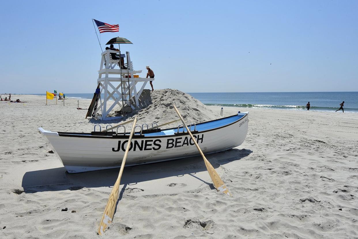 A lifeguard climbs a stand to join colleagues at Field Four at Jones Beach State Park