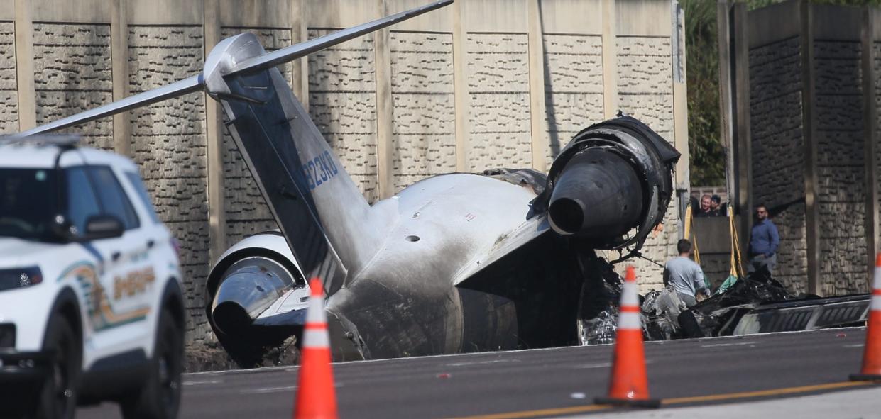 Emergency officials investigate the scene of a plane crash on I-75 in Naples near exit 105 on Saturday, Feb. 10, 2024. The plane carrying five people crashed on Friday, Feb. 9, 2023. Two people are confirmed dead.