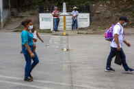 Honduran migrants return to their country of origin at the border crossing in El Florido, Guatemala, Tuesday, Jan. 19, 2021. A once large caravan of Honduran migrants that pushed its way into Guatemala last week had dissipated by Tuesday in the face of Guatemalan security forces. (AP Photo/Oliver de Ros)