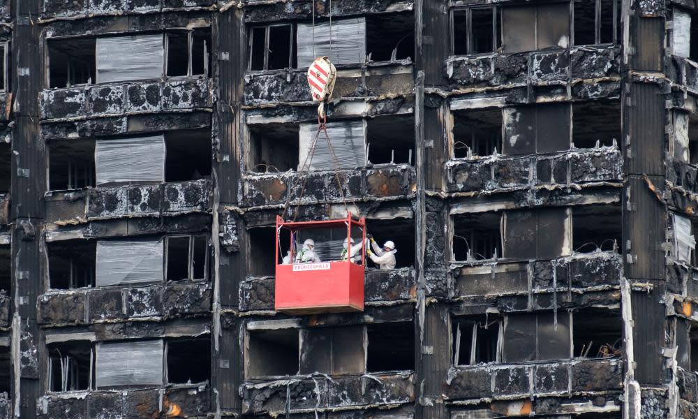 Work begins on covering Grenfell Tower with protective wrapping.