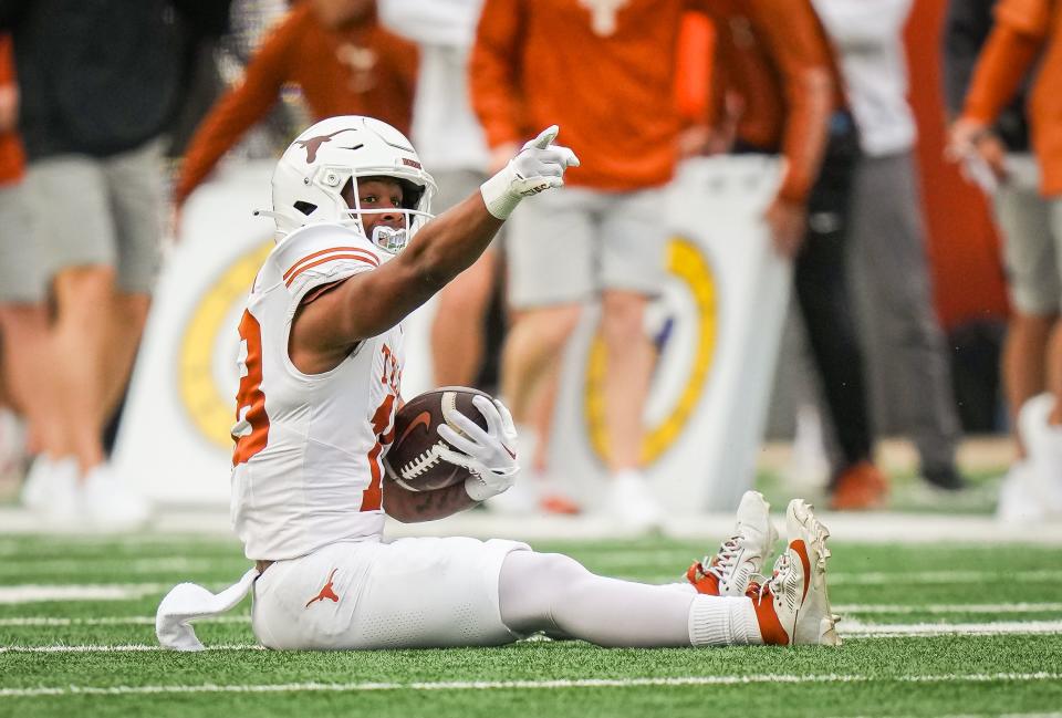 Texas wide receiver Ryan Niblett motions a first down after making a catch during the second quarter of the Orange-White spring game. He's one of several receiving options that provide valuable depth in the receivers' room.