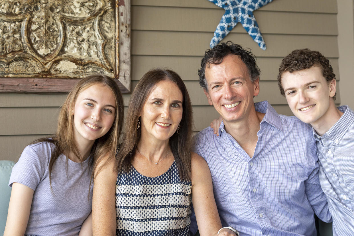 Women smiling with her husband and two children