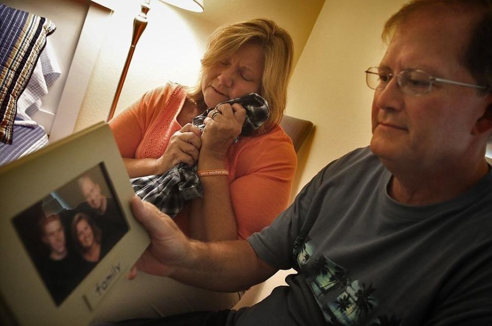 Bryce's parents hold a family photo