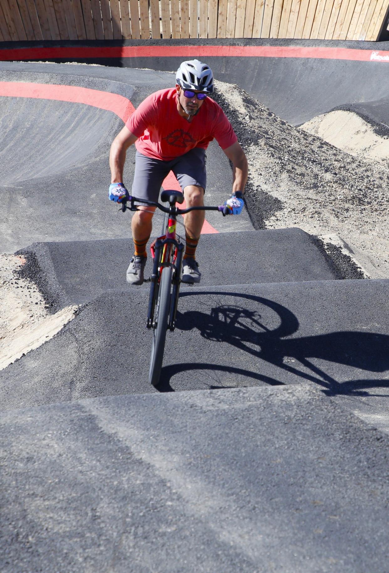 Chris Conley, the president of Farmington Area Single Track, gives a riding demonstration on the new pump track at the San Juan College Bike Park on Wednesday, April 17.