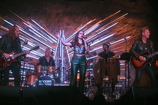 <p>Bobby Bank/Getty</p> Alexa Ray Joel performing on stage at the Rockers on Broadway 30th anniversary concert alongside Tommy Byrnes (left) and Tony Bruno (right).