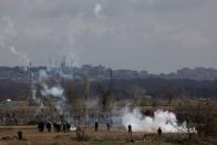 Greek soldiers and riot police officers stand amid clouds of tear gas near Turkey's Pazarkule border crossing, in Kastanies