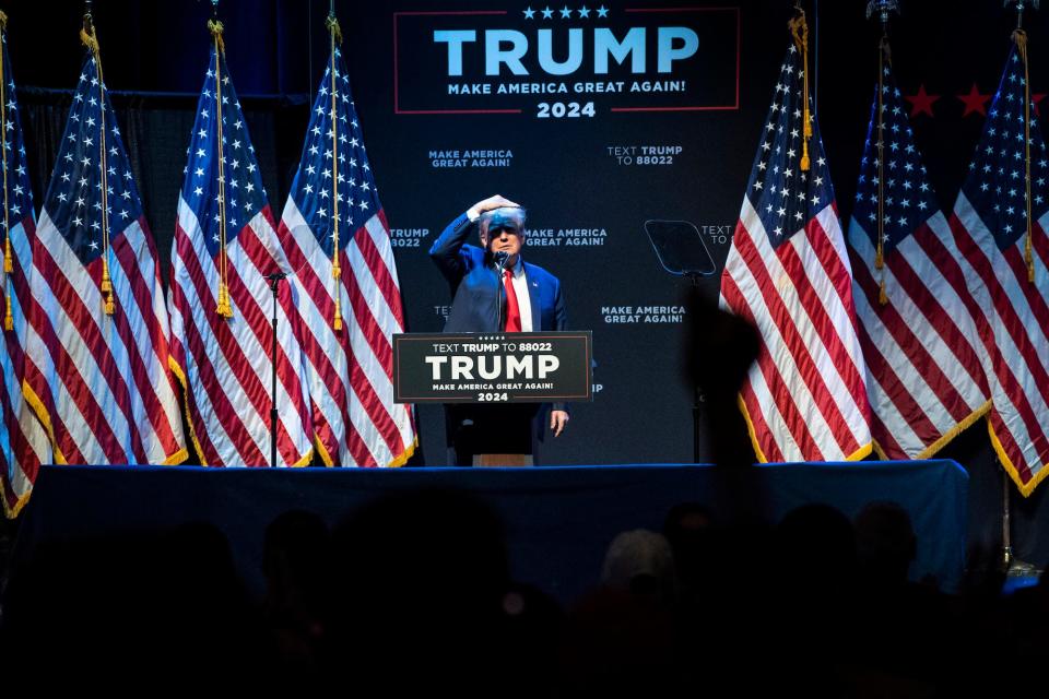 Former US President Donald Trump searches the crowd while speaking during an event at the Adler Theatre on Monday, March 13, 2023, in Davenport, Iowa.