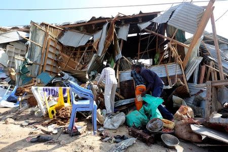 Traders attempt to salvage their goods at the scene of a suicide bomb explosion at the Wadajir market in Madina district of Somalia's capital Mogadishu February 19, 2017. REUTERS/Feisal Omar