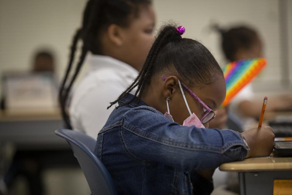 FILE - Students work in a classroom at Beecher Hills Elementary School in Atlanta on Friday, Aug. 19, 2022. The COVID-19 pandemic that shuttered classrooms set back learning in some U.S. school systems by more than a year, with children in high-poverty areas affected the most, according to a district-by-district analysis of test scores shared exclusively with The Associated Press. (AP Photo/Ron Harris, File)