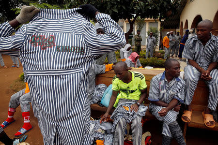 A Kenyan prisoner changes back to his prison uniform after participating in a mock World Cup soccer match between Russia and Saudi Arabia, as part of a month-long soccer tournament involving eight prison teams at the Kamiti Maximum Prison, Kenya's largest prison facility, near Nairobi, Kenya, June 14, 2018. REUTERS/Baz Ratner