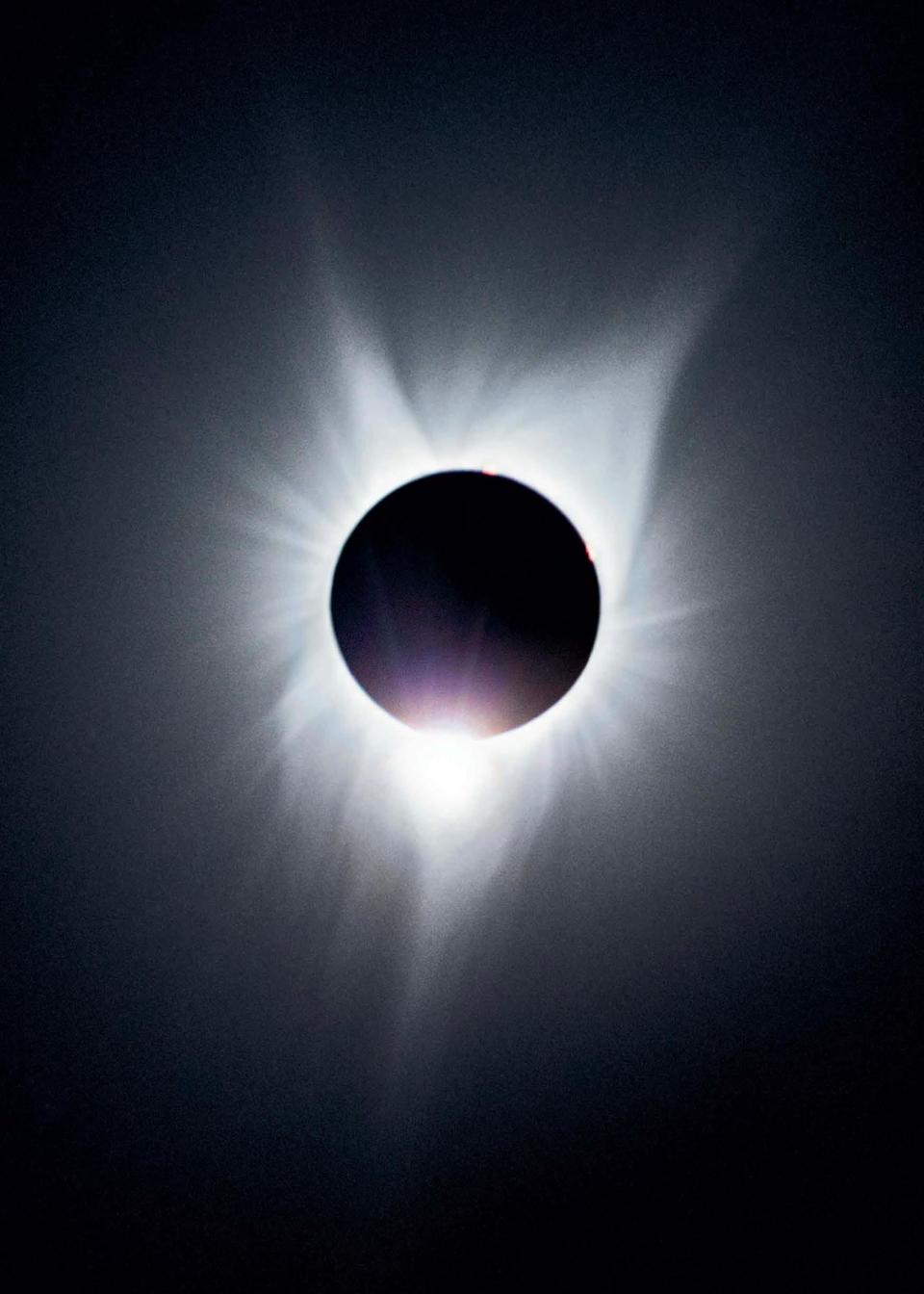 A total solar eclipse with the moon as a black circle on top of the sun.