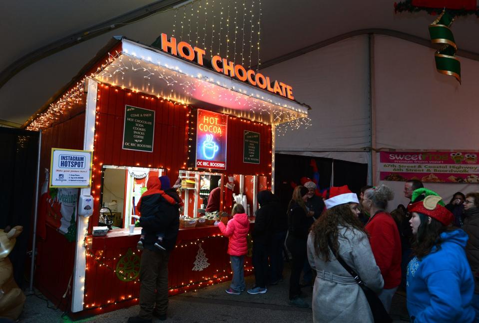 After riding the tram, cold visitors line up for hot chocolate at 2014's Winterfest of Lights at Northside Park in Ocean City.