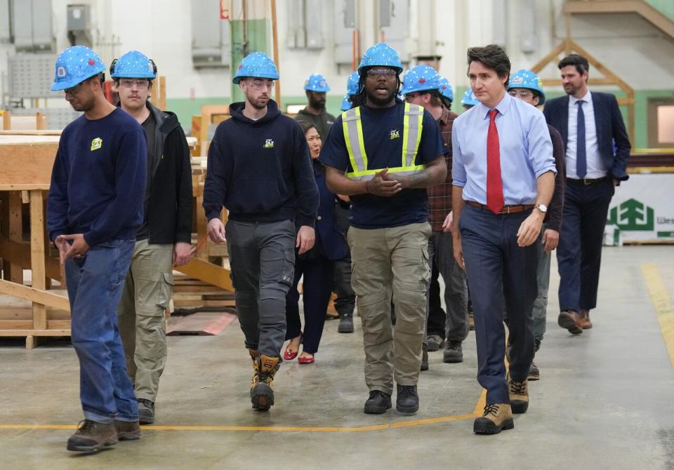 Prime Minister Justin Trudeau, right, meets with carpenters before speaking about new housing solutions at the CCAT training centre in Woodbridge, Ont., on Friday, April 12, 2024.