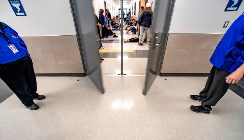 Lipan school district administrators stand outside the safe wing of the high school as the doors close during an evacuation drill. The $9.4 million addition was paid for by a school bond that was overwhelmingly approved by voters in 2021. Photo taken Friday, March 24, 2023.