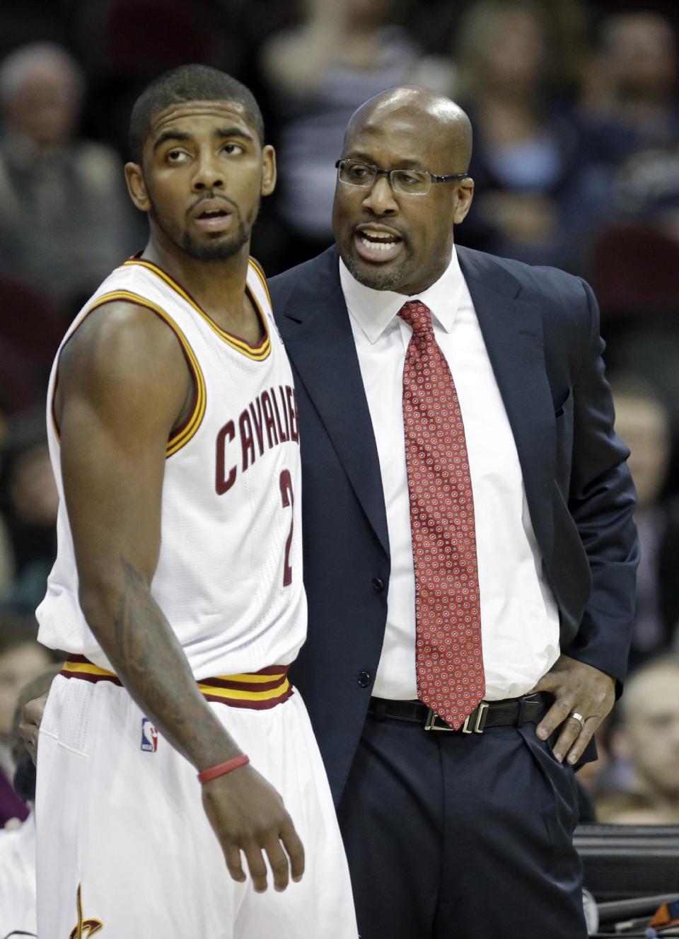 Cleveland Cavaliers head coach Mike Brown, right, talks to Kyrie Irving in the first quarter of an NBA basketball game against the Los Angeles Lakers, Wednesday, Feb. 5, 2014, in Cleveland. (AP Photo/Mark Duncan)
