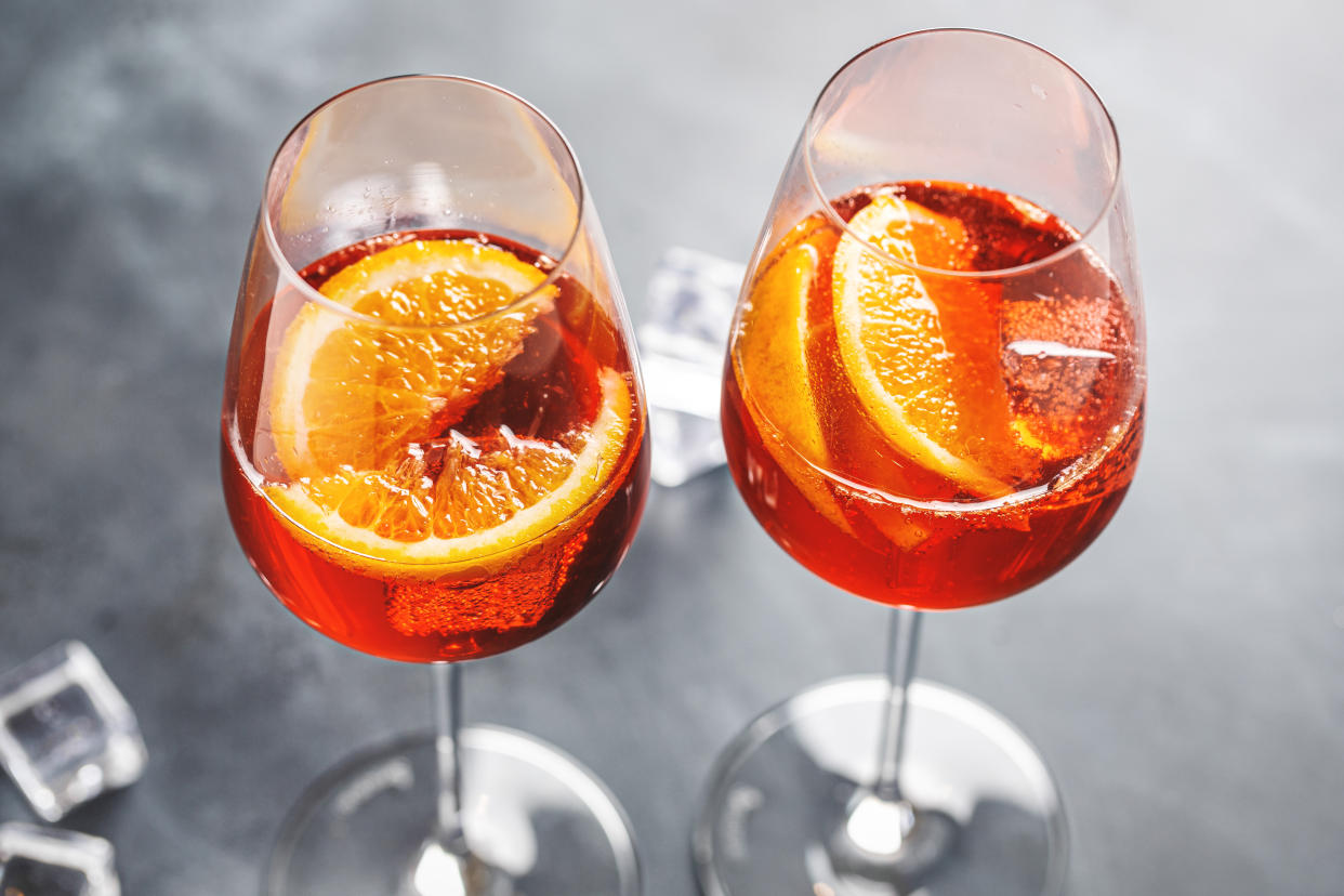 Spritz cocktail with orange slices served in glasses. Closeup