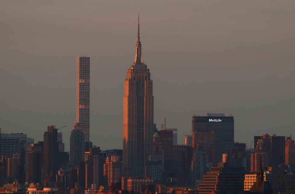 The 1,396-foot building can be seen in the New York City skyline. Here, it appears to the left of the Empire State Building at sunset.