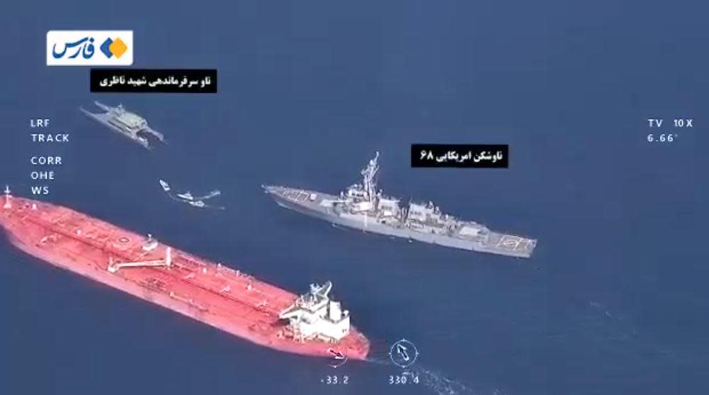 An image taken from video posted online by Iran's Fars News Agency, which is controlled by the country's Islamic Revolutionary Guard Corps (IRGC), on November 3, 2021, purportedly shows an encounter between a U.S. Navy warship and IRGC forces in the Gulf of Oman. Iranian media said the incident occurred near the end of October, 2021, when the U.S. Navy attempted to block passage of a large tanker carrying Iranian oil. / Credit: Fars News Agency