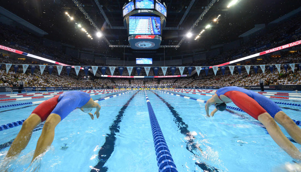 FILE - In this July 1, 2016, file photo, Elizabeth Beisel, left, and Missy Franklin start the women's 200-meter backstroke semifinal at the U.S. Olympic swimming trials in Omaha, Neb. The U.S. Olympic swimming trials will be split into two meets, a radical change that is designed to provide safer conditions in the midst of the coronavirus pandemic. USA Swimming announced Tuesday, Jan. 26, 2021, that a Wave I meet, comprised of lower-ranked swimmers qualifying for the trials, will be held on June 4-7. The top finishers will advance to the main Wave II meet on June 13-20 to determine who represents the U.S at the Tokyo Games. (AP Photo/Mark J. Terrill, File)