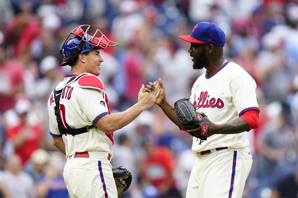 Philadelphia Phillies pitcher Enyel De Los Santos, right, and catcher J.T. Realmuto celebrate after the Phillies won a baseball game against the New York Yankees, Sunday, June 13, 2021, in Philadelphia. (AP Photo/Matt Slocum)