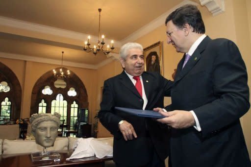 Cypriot President Demitris Christofias (L) welcomes European Commission President Jose Manuel Barroso (R) at the Presidential Palace in Nicosia after experts from the European Commission, the European Central Bank and the International Monetary Fund arrived in Cyprus on July 3, to look into the eurozone member's request for financial aid