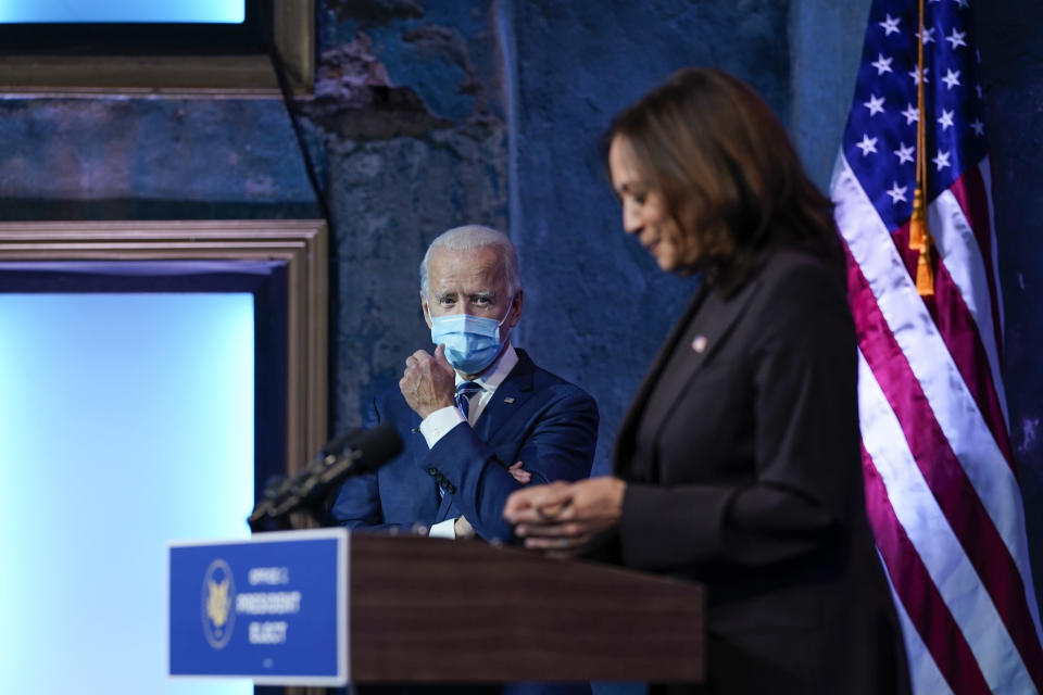 President-elect Joe Biden listens as Vice President-elect Kamala Harris speaks Tuesday, Nov. 10, 2020, at The Queen theater in Wilmington, Del. (AP Photo/Carolyn Kaster)