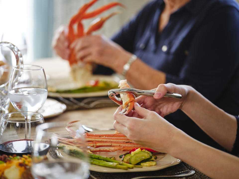 Cracking crab legs at a dinner table