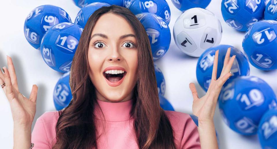 A woman is pictured with the Powerball balls.