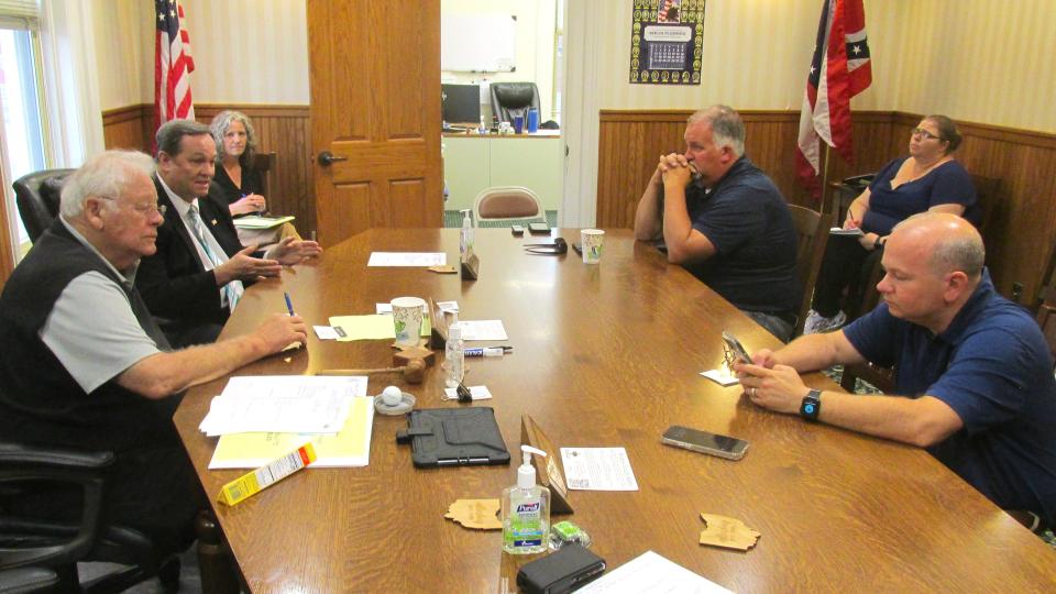 Holmes County Commissioners Joe Miller (clockwise, from left) and Dave Hall talk with State Representative Darrell Kick and State Senator Andrew Brenner about the traffic problem in Holmes County at the intersection of state Route 557 and 39, just west of Berlin. The commissioners have asked the state legislators for help in possibly getting ODOT to expedite their five-year plan.