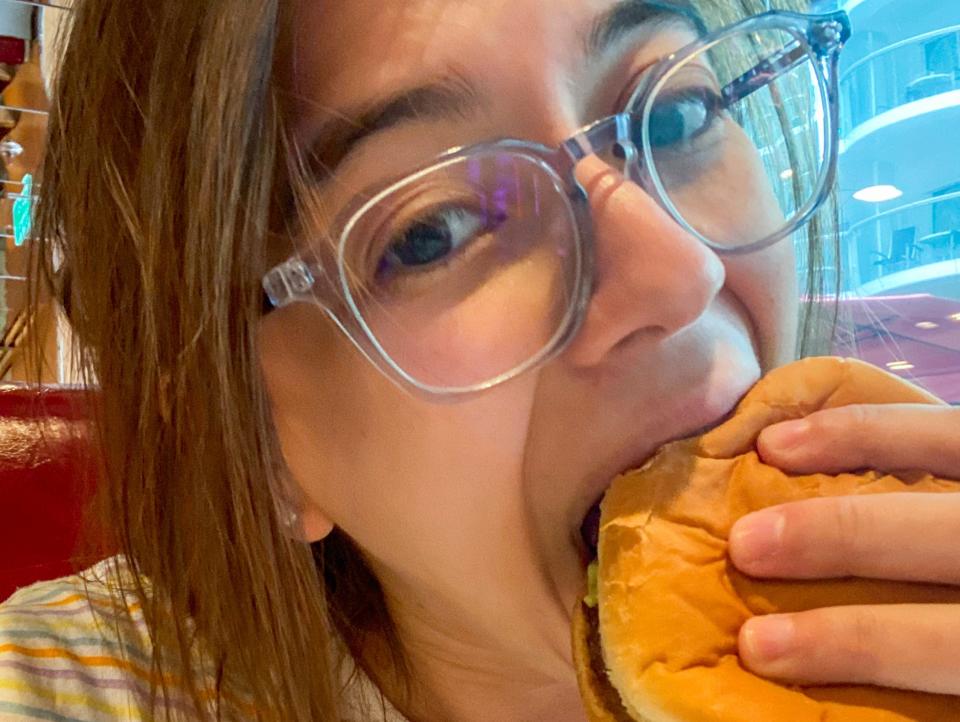 The author takes a bite of the burger