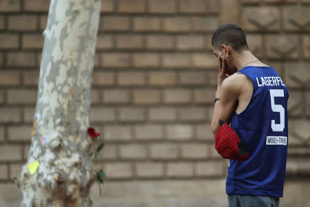 A man stands by an impromptu memorial where a van crashed into pedestrians at Las Ramblas in Barcelona, Spain, August 20, 2017. REUTERS/Susana Vera