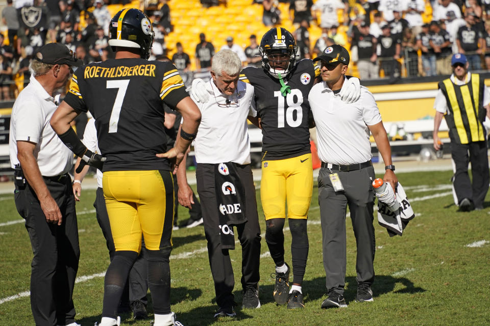 Pittsburgh Steelers quarterback Ben Roethlisberger (7) watches as wide receiver Diontae Johnson (18) is helped off the field after being injured during the second half of an NFL football game against the Las Vegas Raiders in Pittsburgh, Sunday, Sept. 19, 2021. (AP Photo/Keith Srakocic)