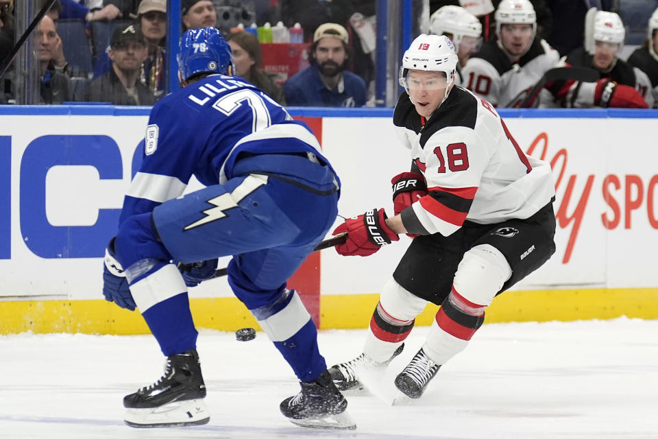 New Jersey Devils left wing Ondrej Palat (18) shoots the puck past Tampa Bay Lightning defenseman Emil Martinsen Lilleberg (78) during the first period of an NHL hockey game Saturday, Jan. 27, 2024, in Tampa, Fla. (AP Photo/Chris O'Meara)